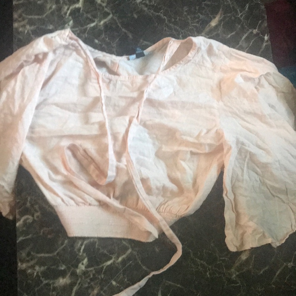 a pink ruffled shirt